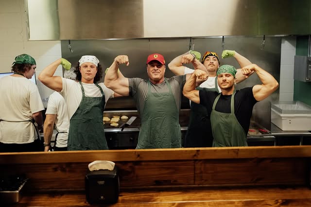 The Tallow House crew in green aprons behind the flat-top griddle in Cleveland, TN